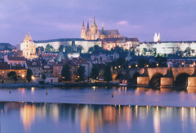 A picture of Prague Castle overlooking the Vlata River at dusk